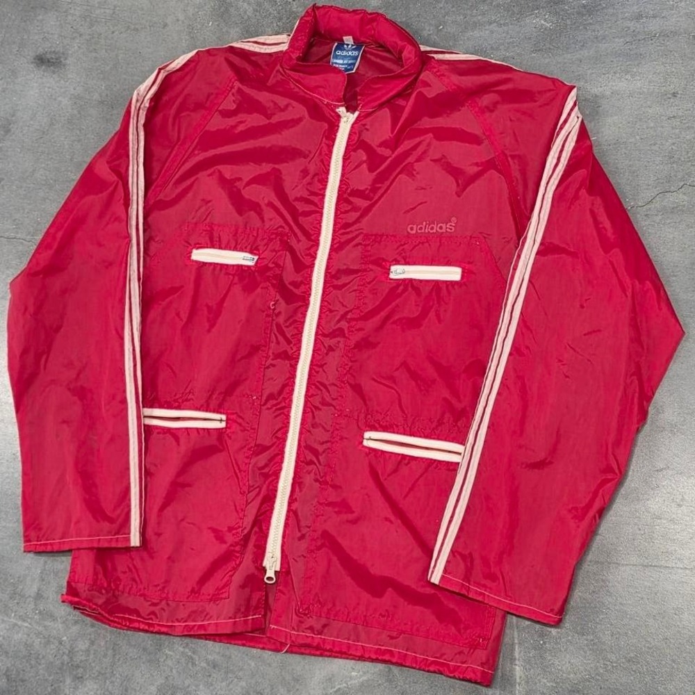 Vintage 80s Adidas red windbreaker with white piping details and zipper pockets